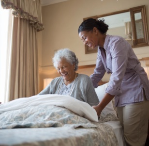Nurse helping senior patient in nursing  

home setting, hospice care Winfield KS 