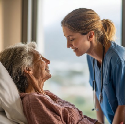 Hospice nurse comforting elderly woman in bed, hospice care in Muskogee OK